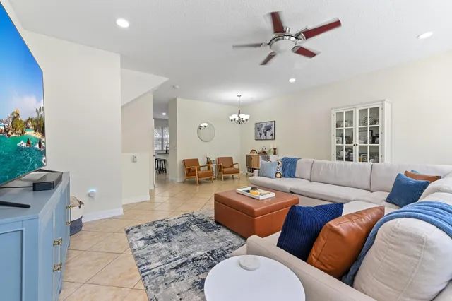 a living room with furniture potted plant and a rug