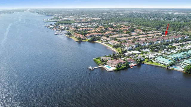 an aerial view of a house with a garden and seating space