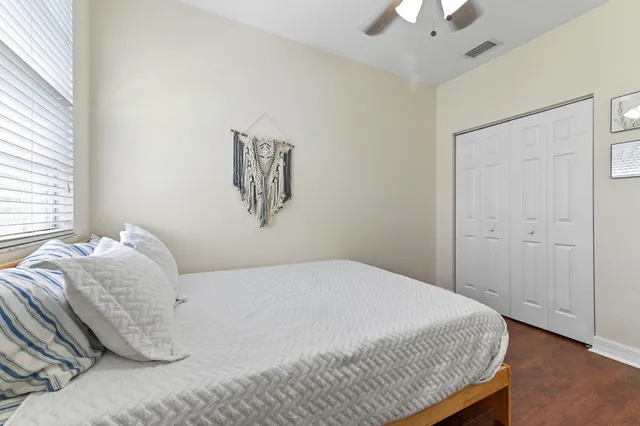 a bedroom with a bed and a window