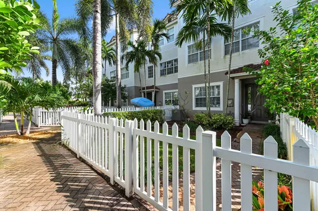 a view of a house with wooden fence