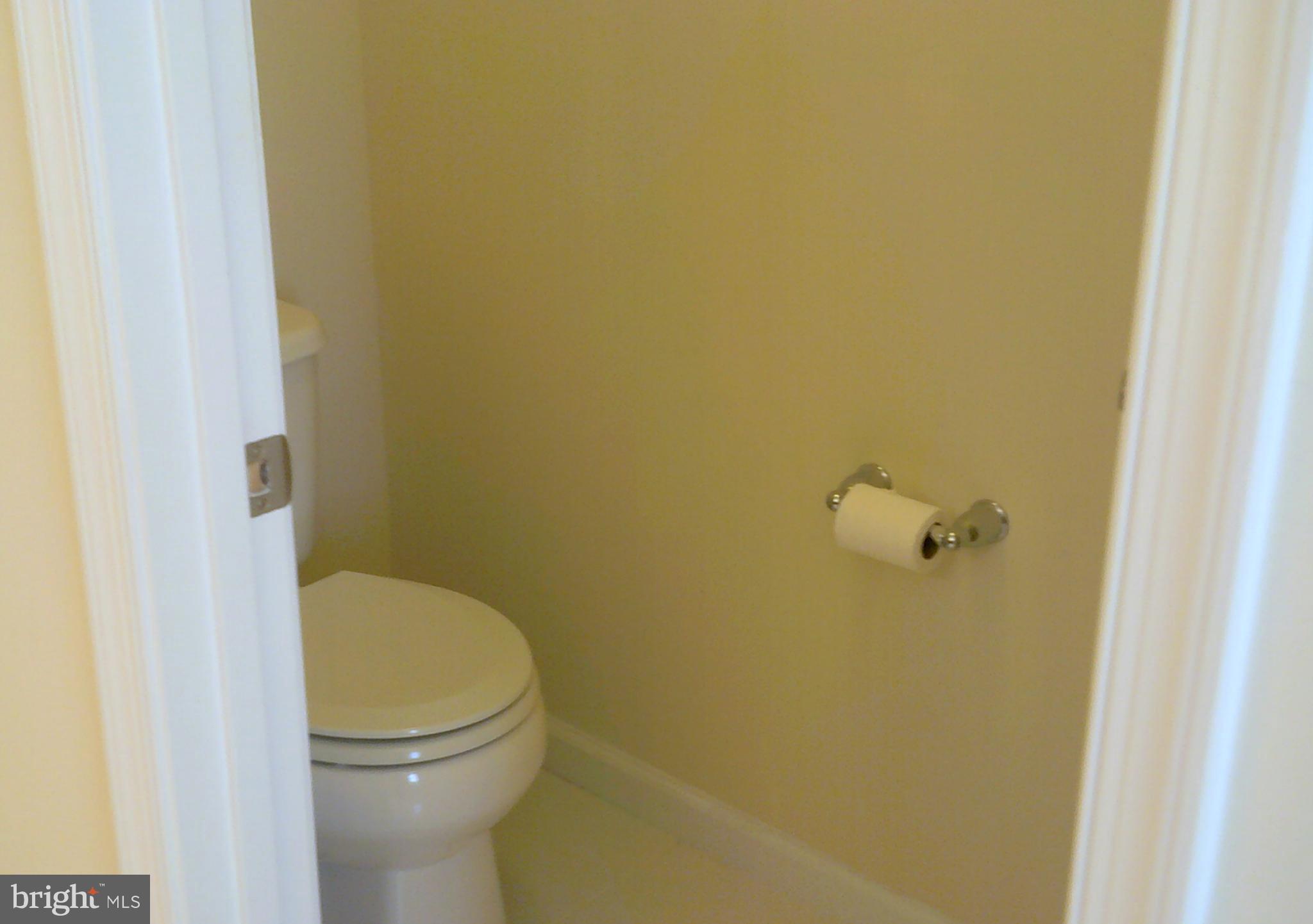 8708 Sagebrush Lane Laurel, MD 20724 - Photo 13 of 29 a bathroom with a granite countertop toilet and a sink