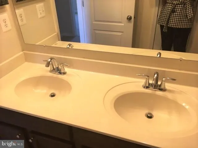 a bathroom with a granite countertop sink a toilet and shower