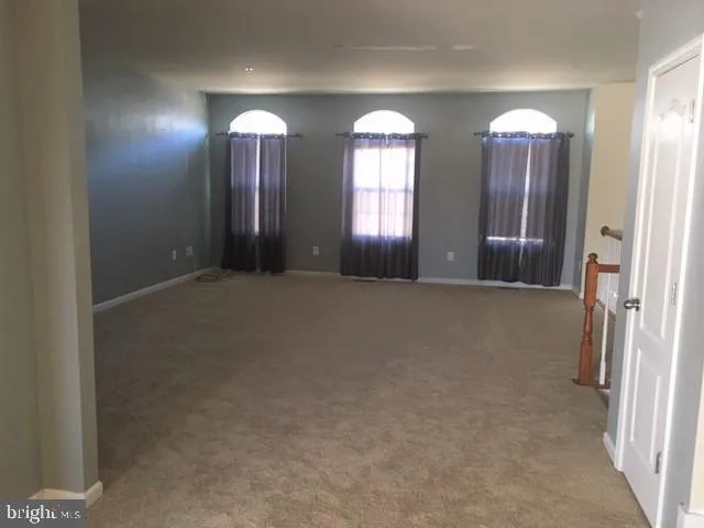 an empty room with closet area