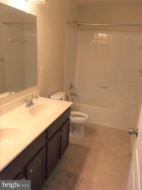 8708 Sagebrush Lane Laurel, MD 20724 - Photo 20 of 29 a bathroom with a granite countertop sink a toilet and shower