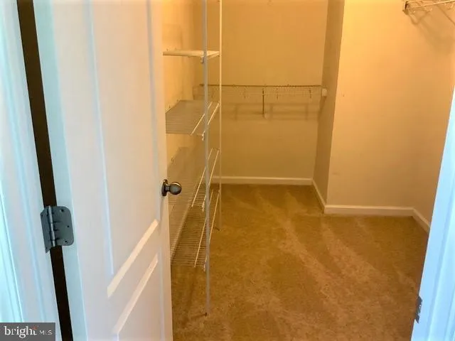 a view of staircase with railing and white door