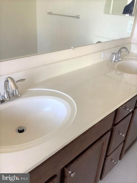 8708 Sagebrush Lane Laurel, MD 20724 - Photo 23 of 29 a bathroom with a sink and a mirror