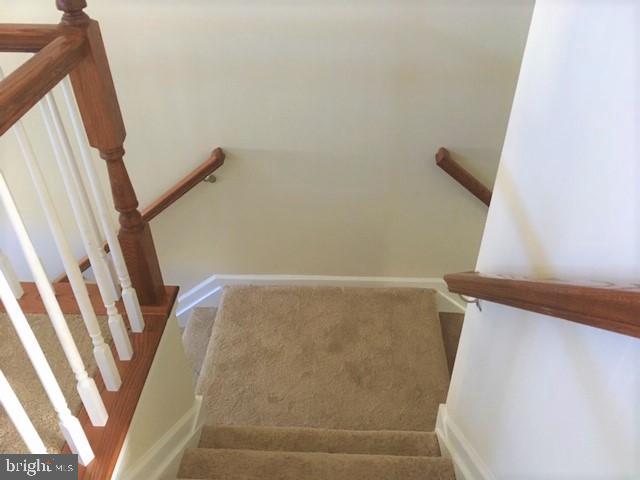8708 Sagebrush Lane Laurel, MD 20724 - Photo 26 of 29 a view of staircase with railing and white door