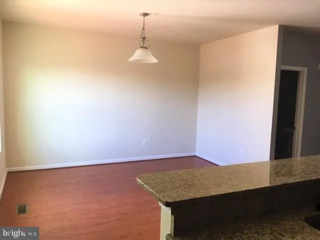 a white toilet sitting next to a white cabinet