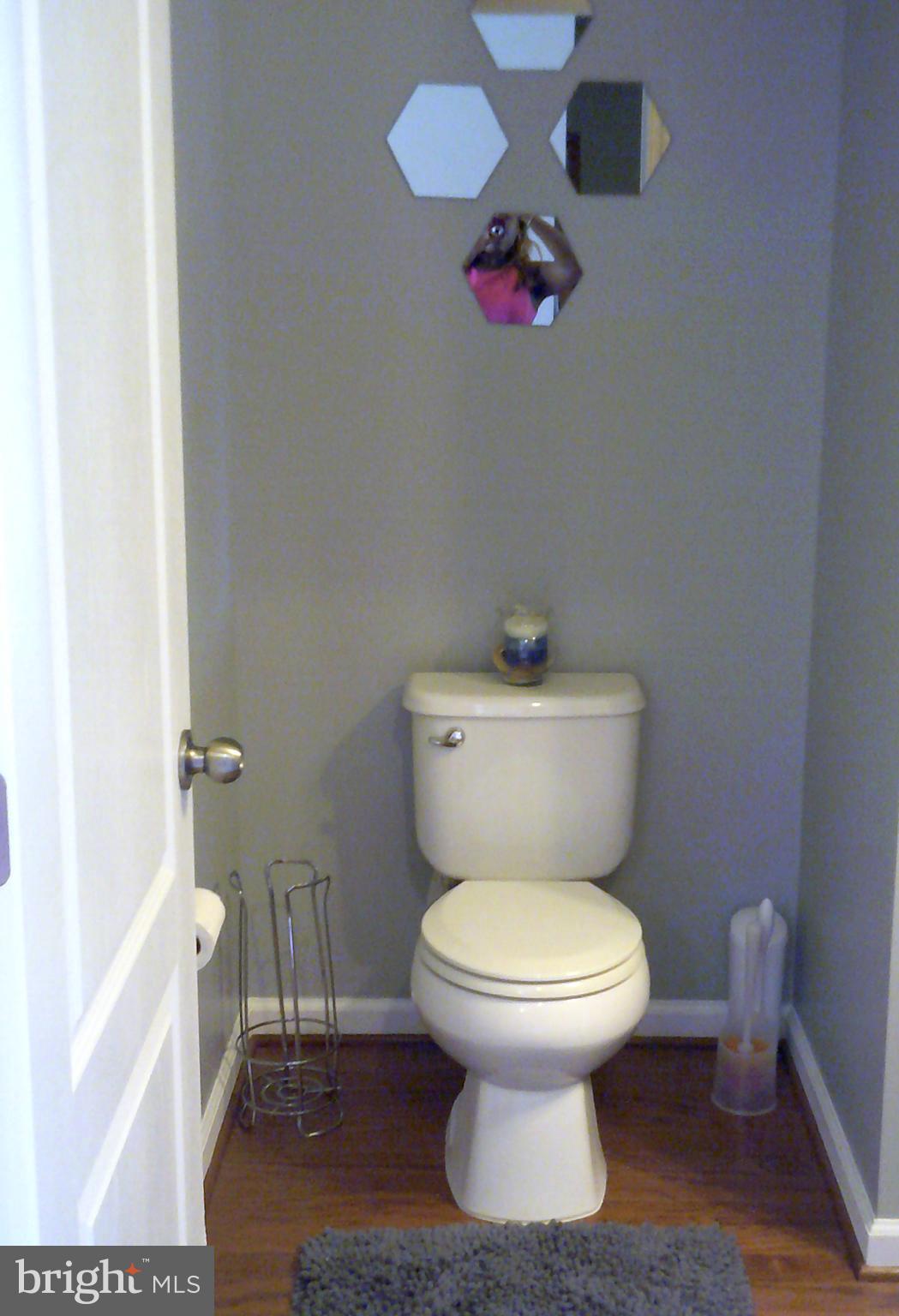 8708 Sagebrush Lane Laurel, MD 20724 - Photo 9 of 29 a white toilet sitting next to a white cabinet