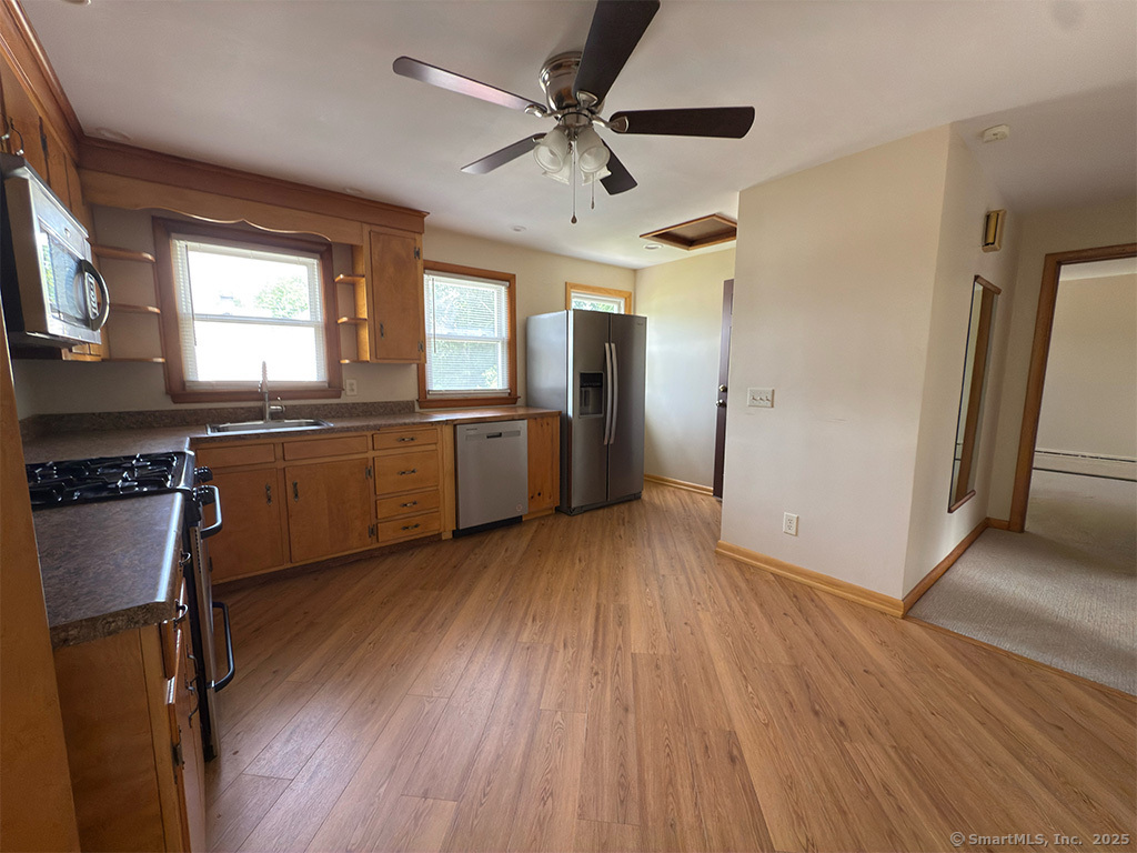 65 1st Avenue, Unit 2 New Haven, CT 06513 - Photo 4 of 13 a kitchen with stainless steel appliances granite countertop a hardwood floor sink stove and a refrigerator