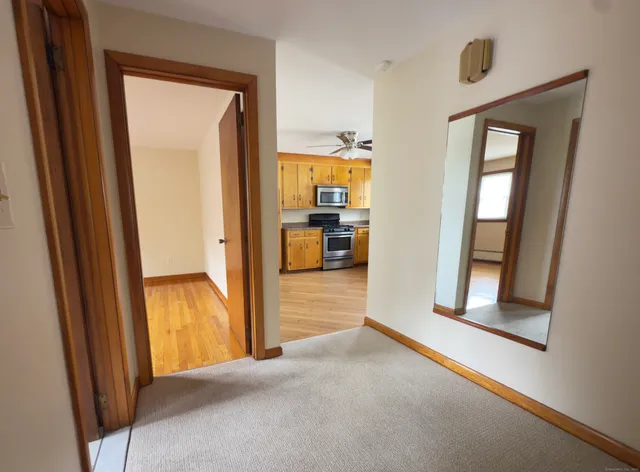 a view of a hallway view with wooden floor and furniture