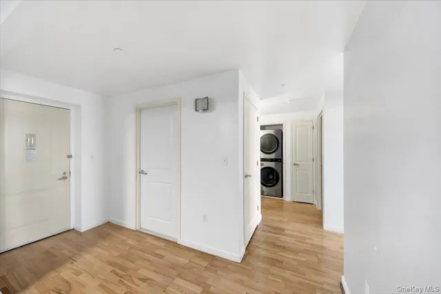 a view of a hallway with wooden shelves