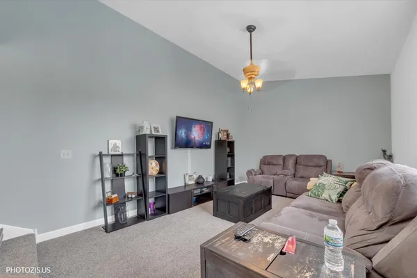 a living room with furniture and a chandelier