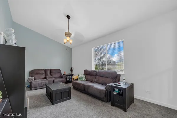 a living room with furniture a window and a flat screen tv