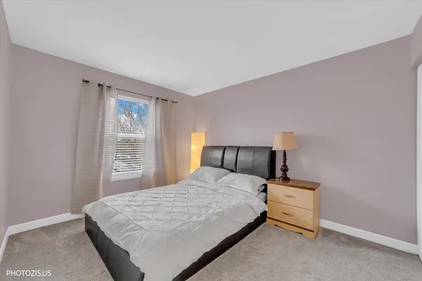 a bedroom with a bed and a night stand