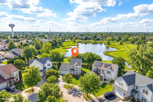 an aerial view of residential house with outdoor space and lake view