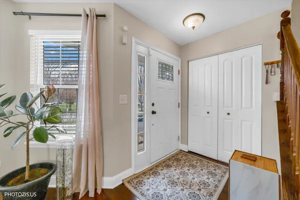 a view of an entryway with wooden floor