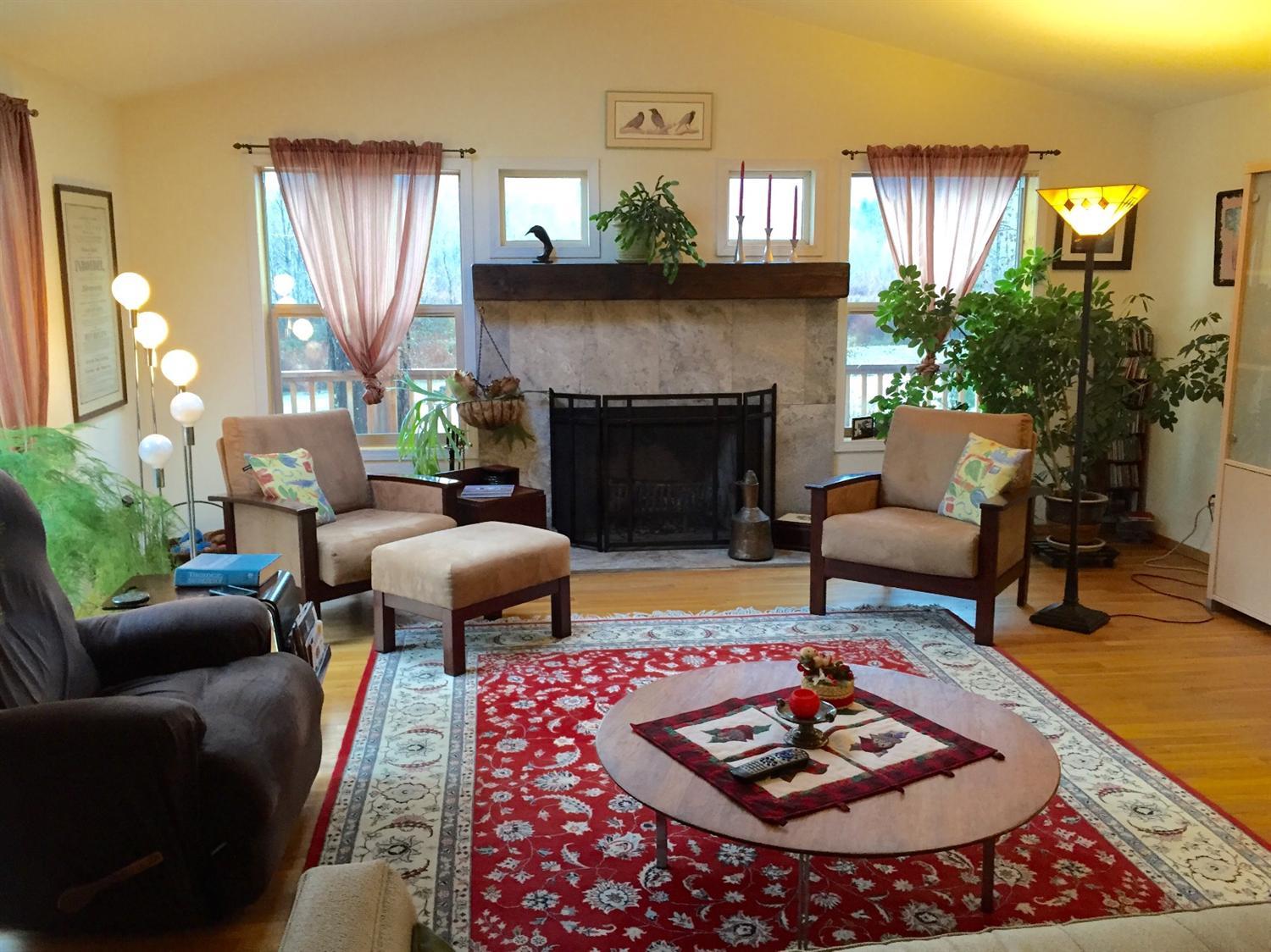 5707 Rockydale Road Cave Junction, OR 97523 - Photo 5 of 35 a living room with furniture and a fireplace