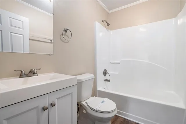 a bathroom with a sink toilet vanity and tub