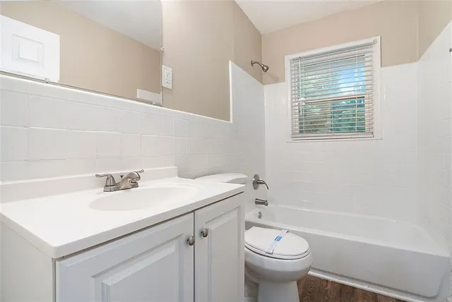 a bathroom with a sink a toilet and a bathtub