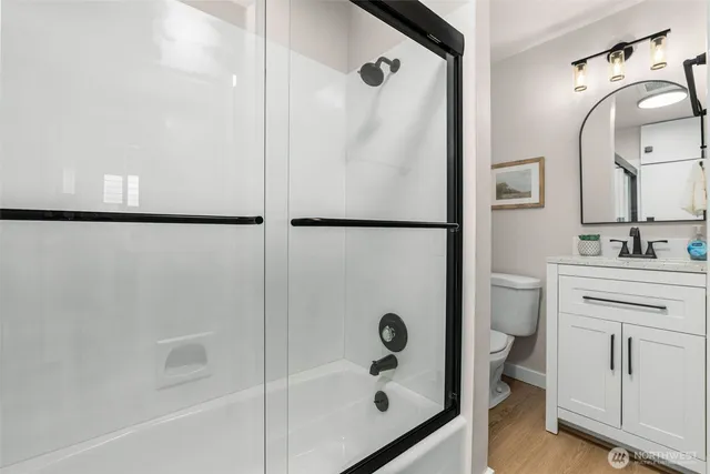 a bathroom with a shower sink and mirror