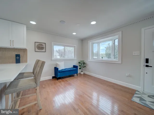 a kitchen with stainless steel appliances granite countertop a refrigerator sink a stove and a refrigerator with wooden floor
