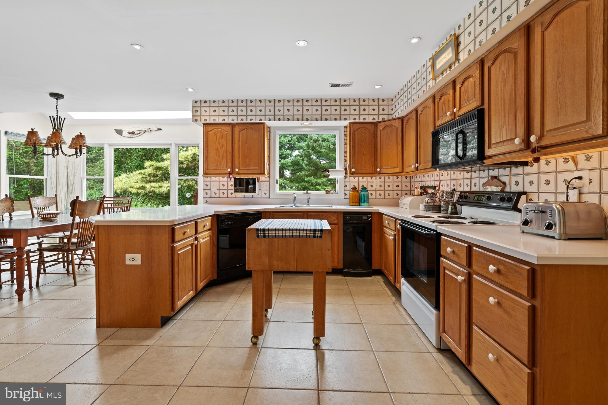1010 Branch Mill Road Telford, PA 18969 - Photo 19 of 74 a kitchen with stainless steel appliances granite countertop a sink counter space cabinets and a large window