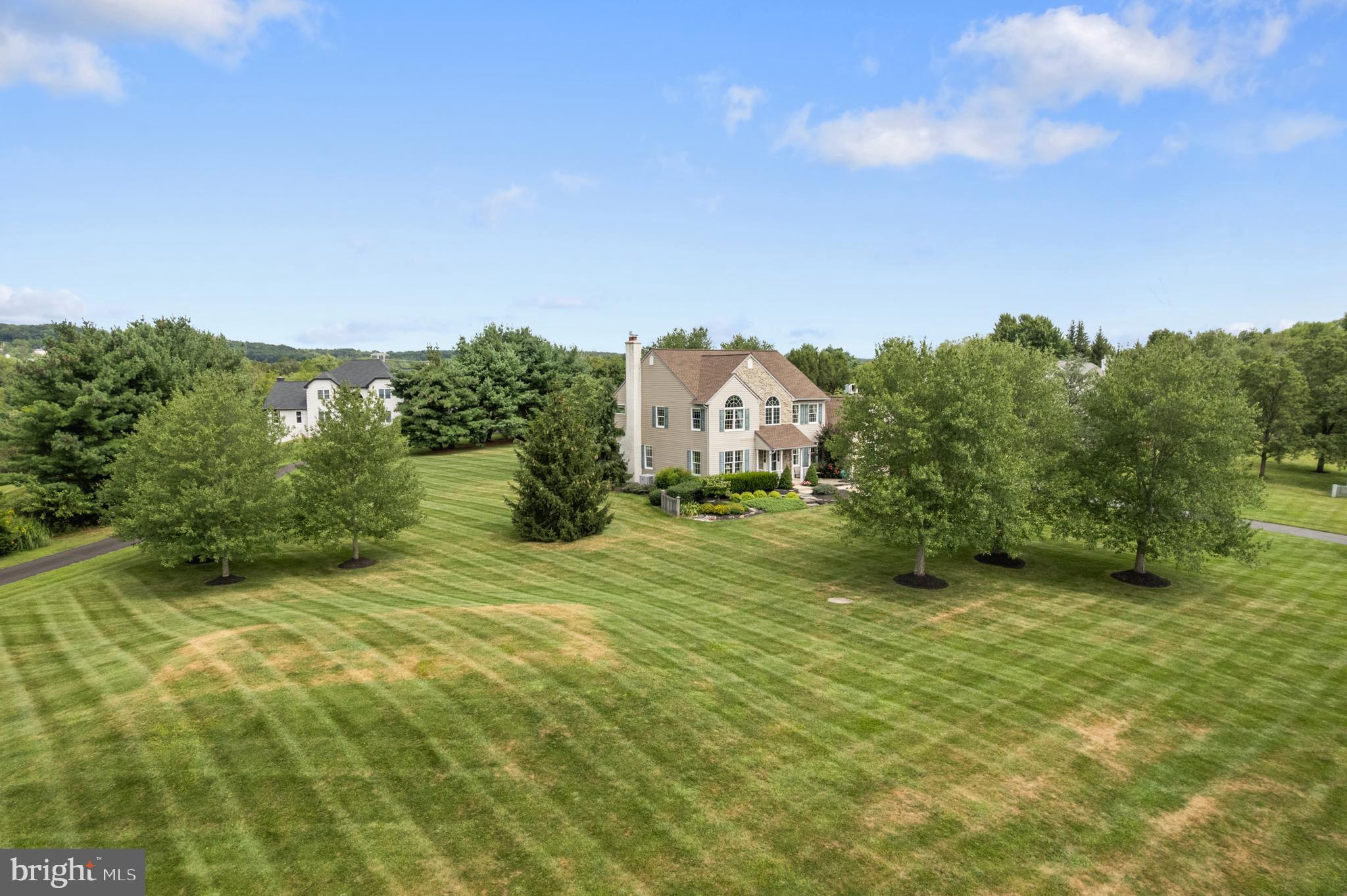 1010 Branch Mill Road Telford, PA 18969 - Photo 4 of 74 a view of a big yard with potted plants and large tree