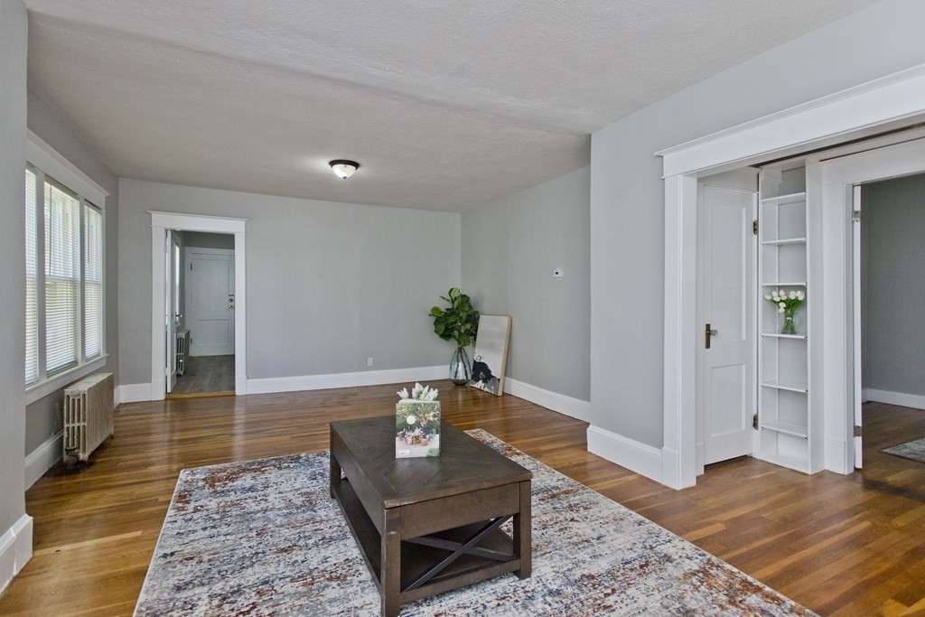 52-54 Draper Street Springfield, MA 01108 - Photo 11 of 31 a living room with furniture and wooden floor