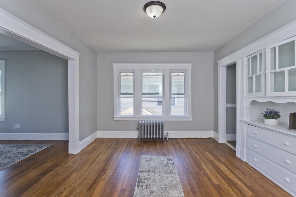 52-54 Draper Street Springfield, MA 01108 - Photo 22 of 31 an empty room with wooden floor and windows
