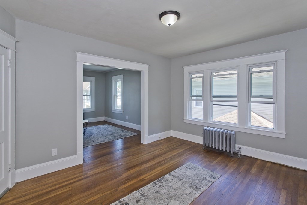 52-54 Draper Street Springfield, MA 01108 - Photo 23 of 31 an empty room with wooden floor and windows