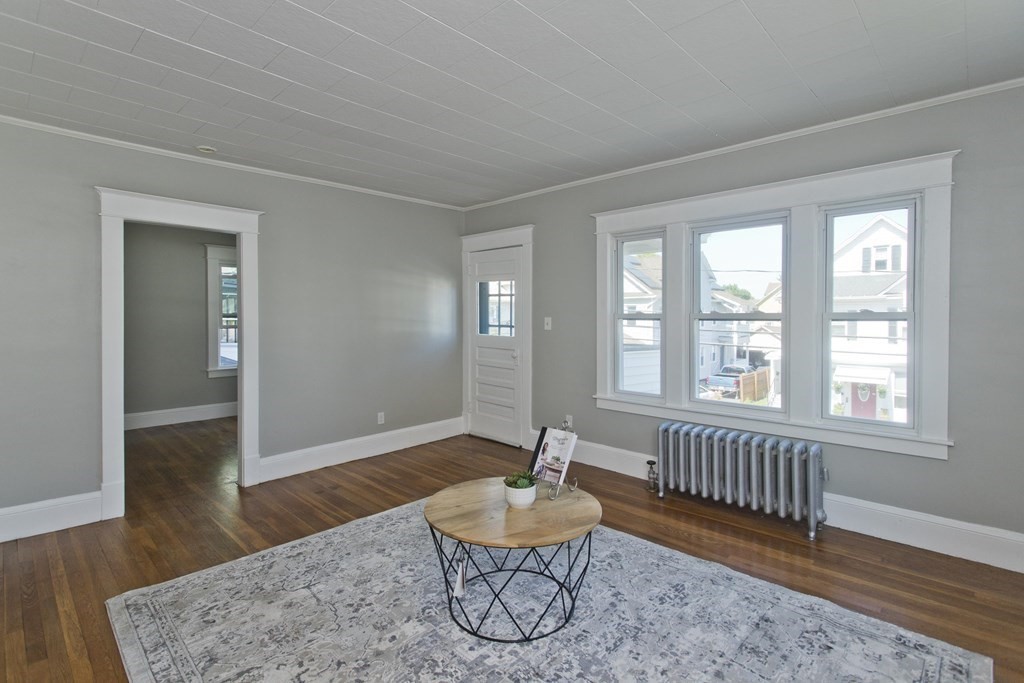 52-54 Draper Street Springfield, MA 01108 - Photo 24 of 31 a living room with furniture and a window