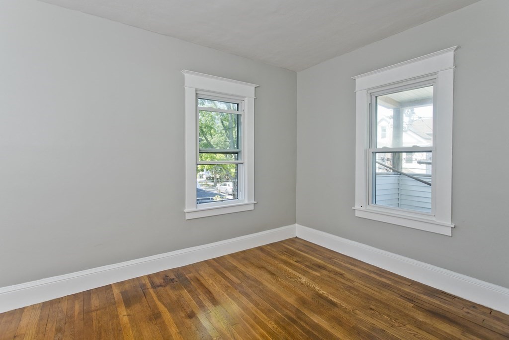 52-54 Draper Street Springfield, MA 01108 - Photo 26 of 31 an empty room with wooden floor and windows