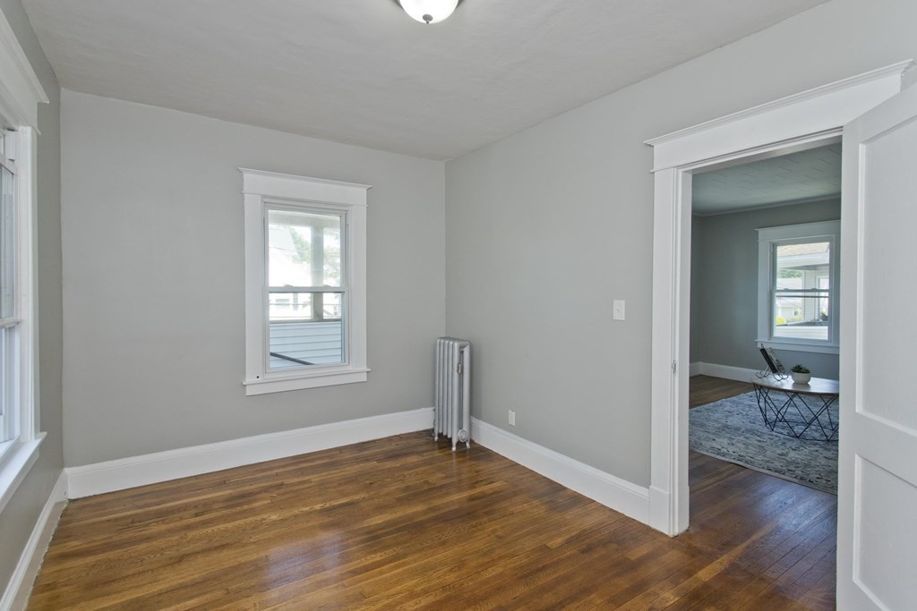 52-54 Draper Street Springfield, MA 01108 - Photo 28 of 31 an empty room with wooden floor and a bathroom