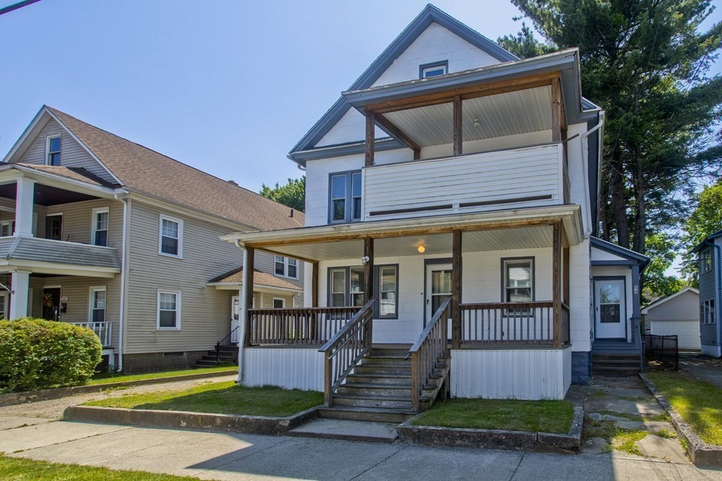 52-54 Draper Street Springfield, MA 01108 - Photo 3 of 31 a front view of a house with a yard table and chairs