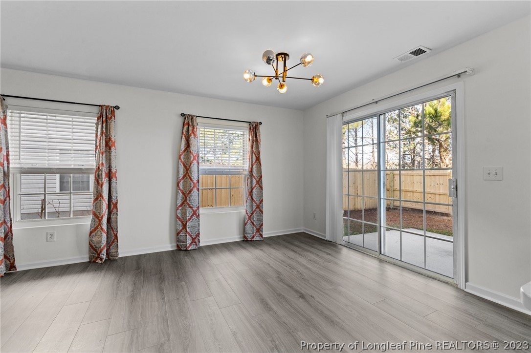 3625 Marshlane Way Raleigh, NC 27610 - Photo 12 of 37 an empty room with wooden floor and windows