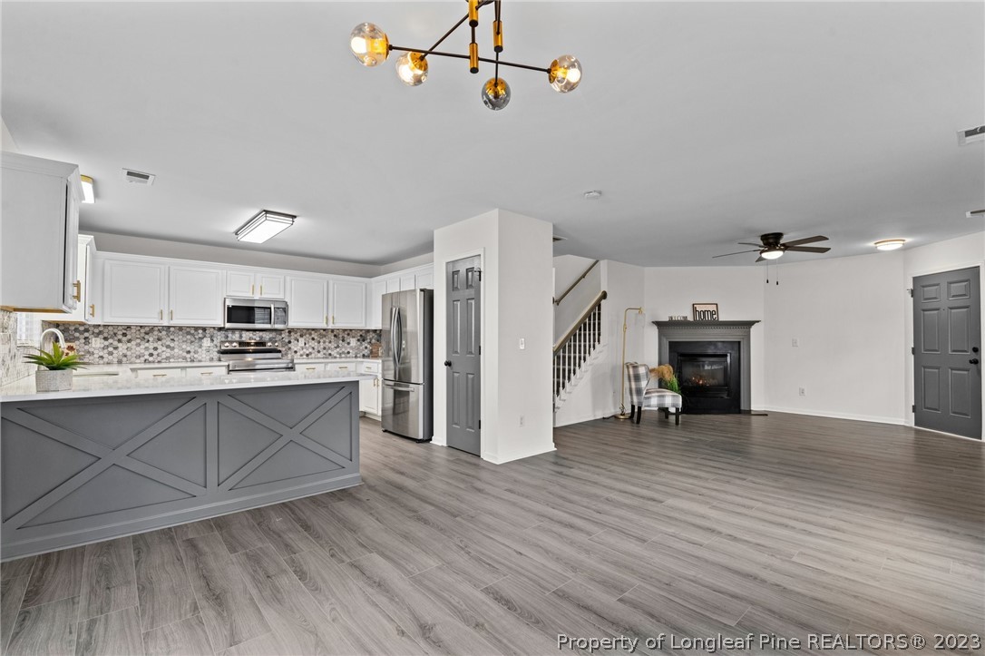 3625 Marshlane Way Raleigh, NC 27610 - Photo 13 of 37 a view of kitchen with cabinets and wooden floor