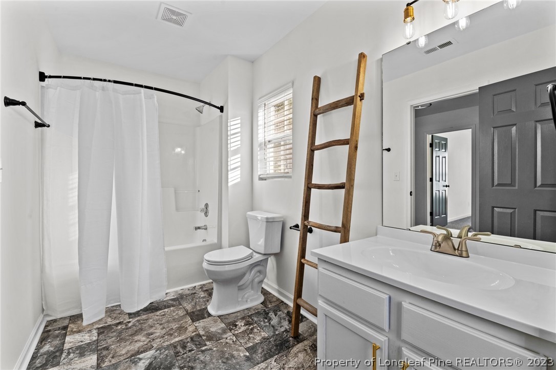 3625 Marshlane Way Raleigh, NC 27610 - Photo 18 of 37 a bathroom with a sink toilet and shower