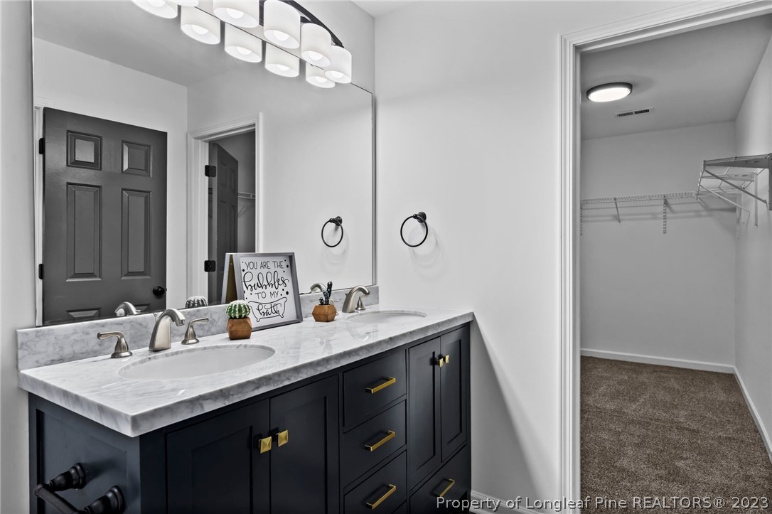3625 Marshlane Way Raleigh, NC 27610 - Photo 26 of 37 a bathroom with a sink a vanity and a mirror