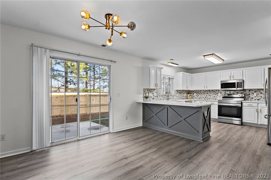 3625 Marshlane Way Raleigh, NC 27610 - Photo 6 of 37 a kitchen with a refrigerator and a stove top oven
