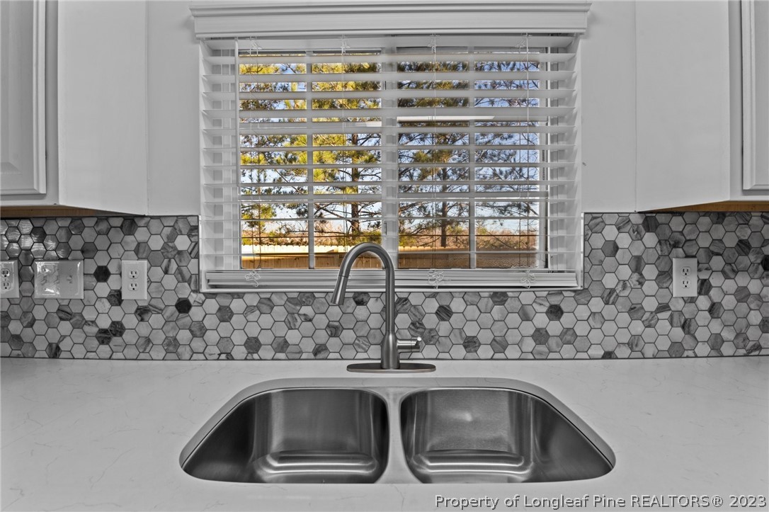 3625 Marshlane Way Raleigh, NC 27610 - Photo 10 of 37 a kitchen sink with granite countertop a sink and cabinets
