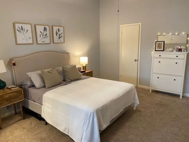 a bed room with a bed and a night stand