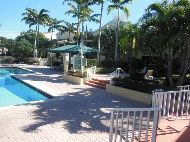 a view of a patio with swimming pool and sitting area