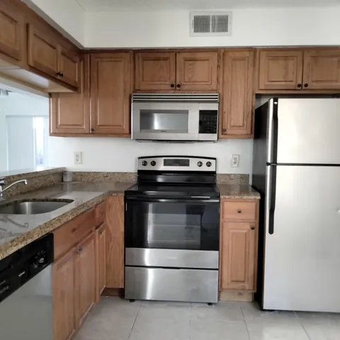 a kitchen with a stove microwave and refrigerator