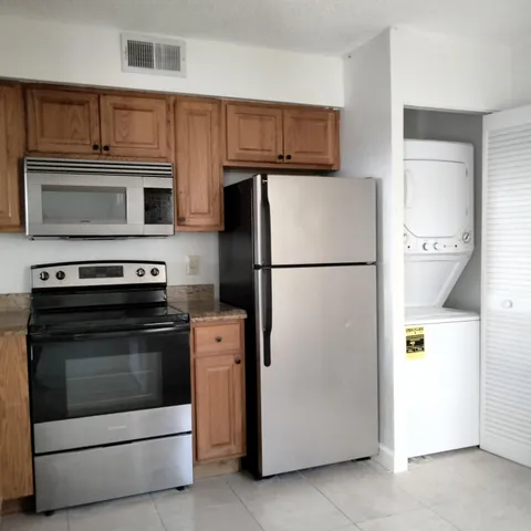 a kitchen with cabinets and stainless steel appliances