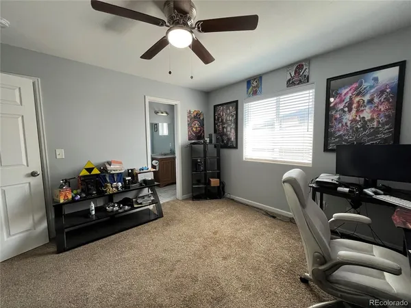 a living room with furniture a flat screen tv and a window