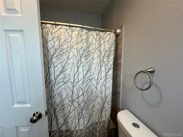 a bathroom with a shower curtain and a sink