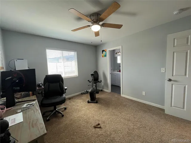 a room with gym equipment and windows