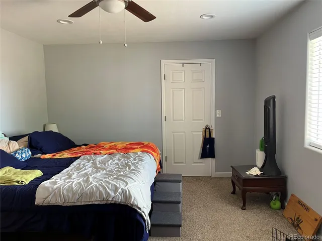 a bedroom with bed and window