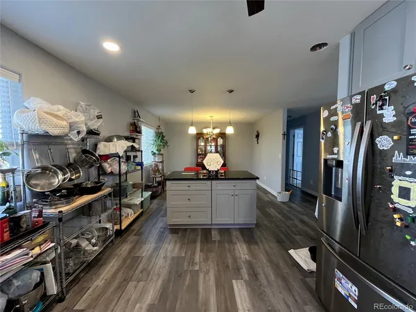 a large kitchen with lots of counter space and wooden floor